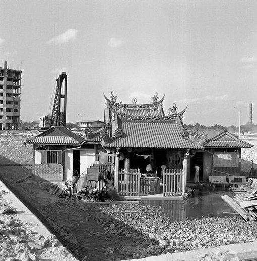 The temple finding itself in a hole in the ground as work on the new public housing estate of Toa Payoh was being carried out in 1968.