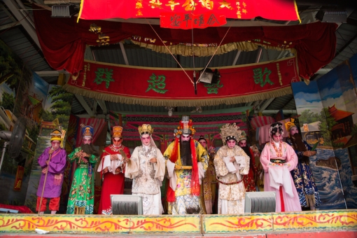 The opera troupe onstage paying respects to the deity.