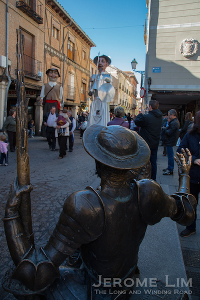 Don Quixote meets the procession along Calle Mayor. 